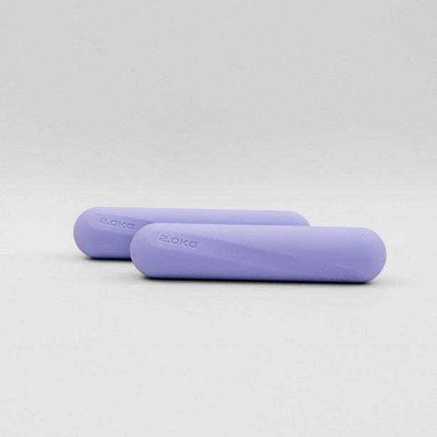 A pair of lavender-colored dumbbell strength bars placed side by side on a light background.