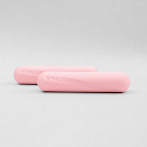 A pair of pink dumbbell strength bars placed side by side on a white background.