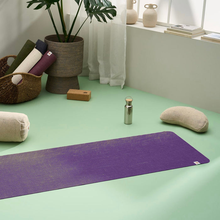 Lifestyle image of jute yoga mat, meditation cushion, yoga bolster, yoga blocks in a stylish modern home yoga studio #colour_new-majestic-purple