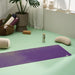 Lifestyle image of jute yoga mat, meditation cushion, yoga bolster, yoga blocks in a stylish modern home yoga studio #colour_new-majestic-purple