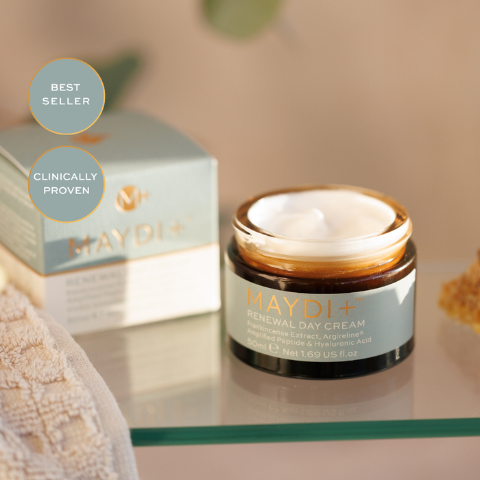 Maydi+ Renewal Day Cream jar with packaging on a glass surface