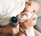 Mother using electric breast pump with one hand